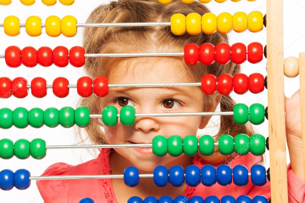 Funny little girl peeping out colorful abacus