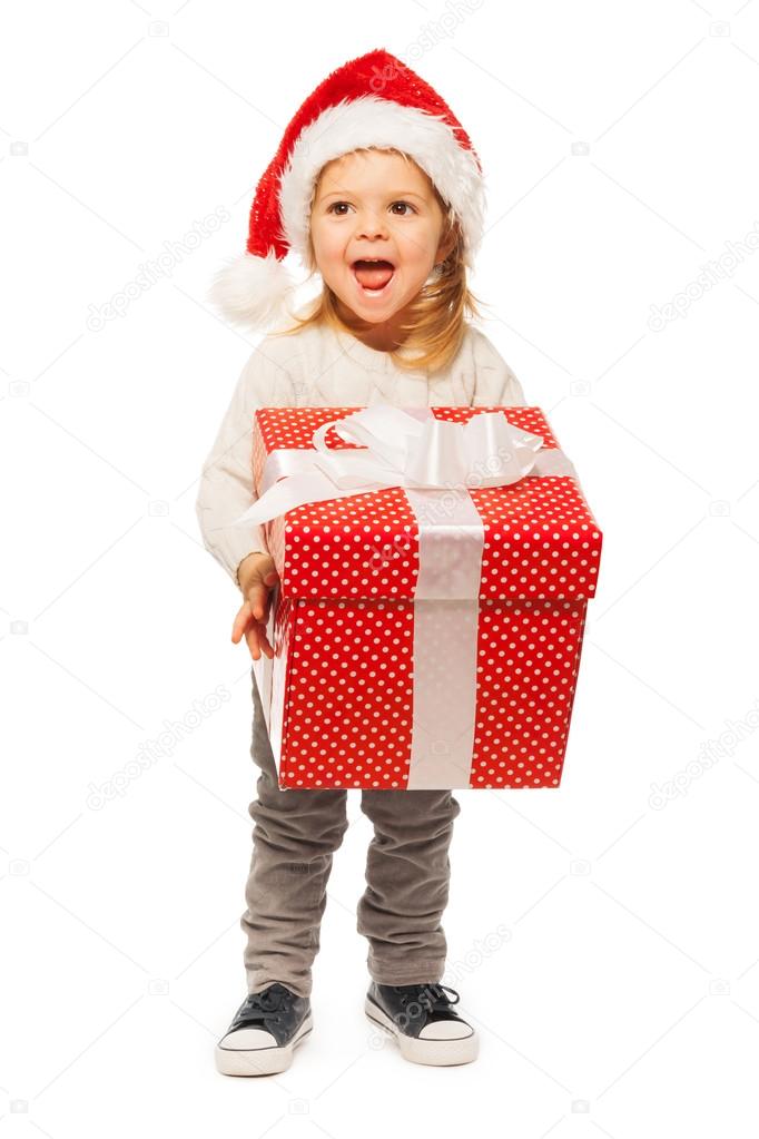 Little girl with big gift box and Santa hat