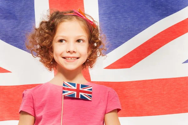 Inglês curly-haired menina com bandeira — Fotografia de Stock