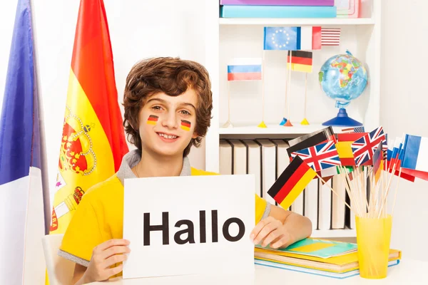 Schoolboy learning German at  classroom — Stock Photo, Image