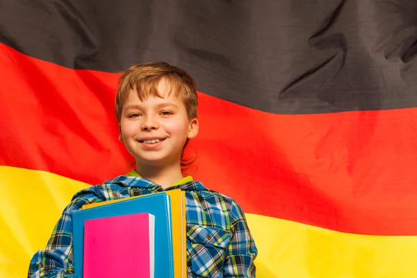 Schoolboy standing near flag of Germany — Stock Photo, Image