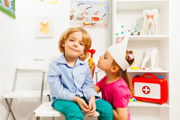 Girl playing ear nose throat specialist — Stock Photo, Image