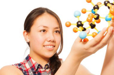 Asian student assembling molecule models