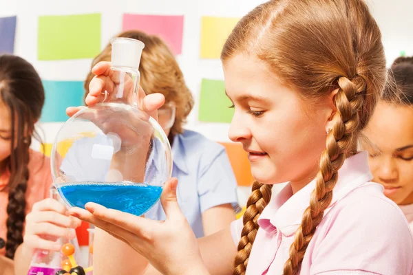 Schoolgirl holding flask — Stock Photo, Image