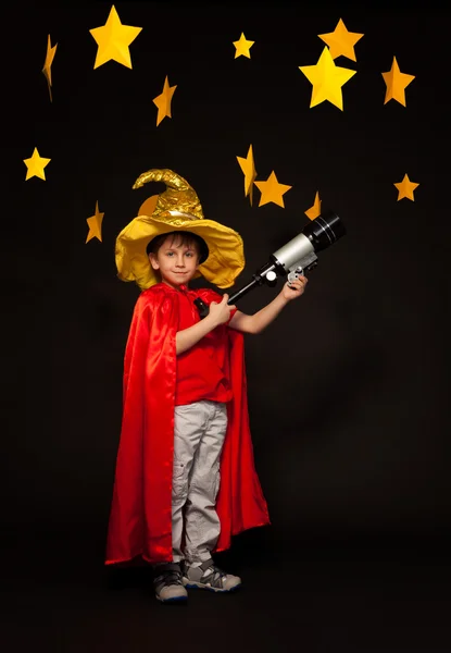 Boy playing stargazer with telescope — Stock Photo, Image