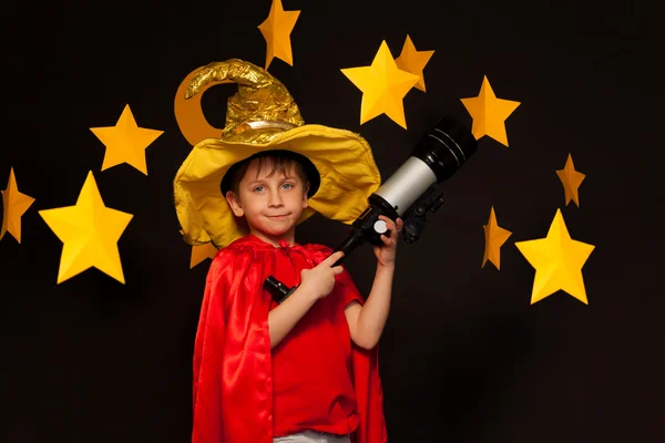 Boy in sky watcher costume with telescope — Stock Photo, Image