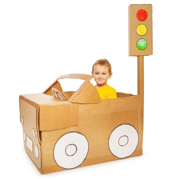 Boy driving his handmade cardboard car — Stock Photo, Image