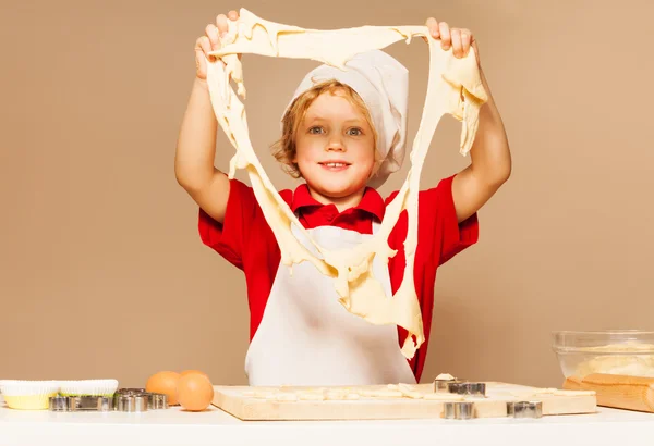 Baker looking through  hole of dough — Stock Photo, Image