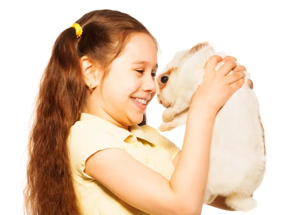 Girl holds little white rabbit — Stock Photo, Image