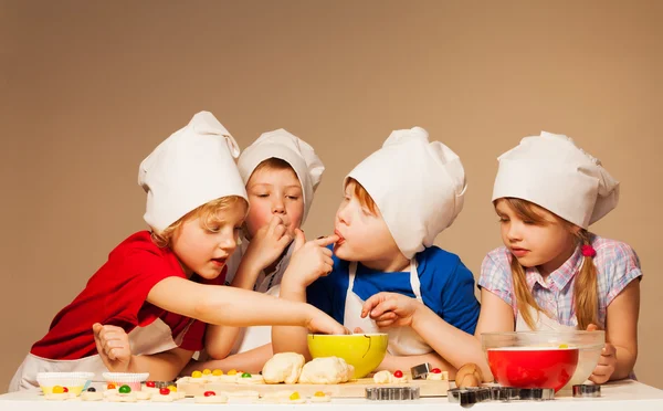 Boys and girl in baker's uniform — Stock Image Boys and girl in baker's uniform Royalty Free Stock Images