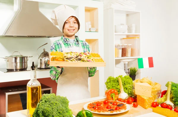 Young cook holding tray — Stock Photo, Image