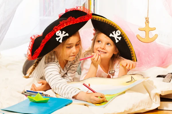 Two girls in tricorns drawing — Stock Photo, Image