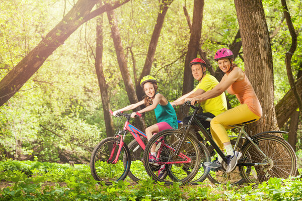 Active smiling family on bikes