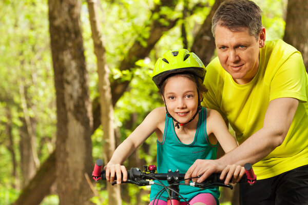 Happy girl learning to cycle 