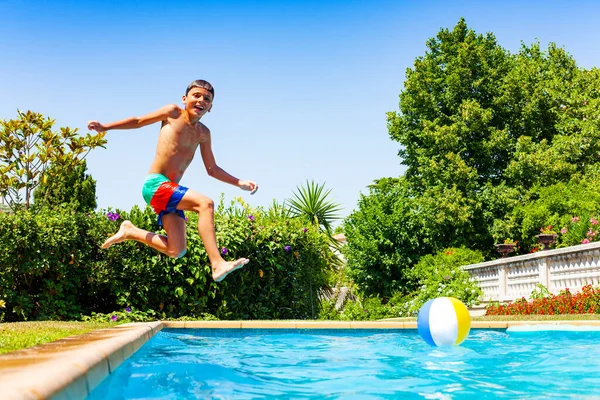 Happy little boy jump in the water diving after long run laugh and smile profile view