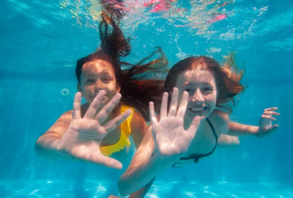 Two Beautiful Girls Swim Underwater Wave Hand Camera Smiling Pool — Stock Photo, Image