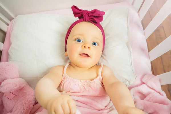 View Little Baby Girl Pink Bed Crib Wearing Red Bow — Stockfoto