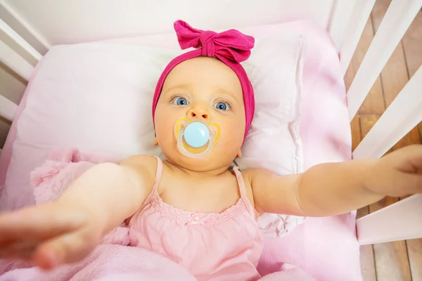 View Top Baby Girl Lay Bed Stretching Hands Pacifier Mouth — Stockfoto