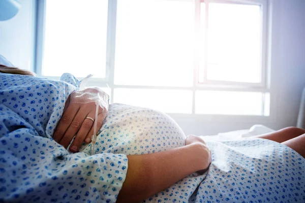 Közelkép Egy Terhes Hasáról Kórházi Ágyban Katéterrel Kezében — Stock Fotó