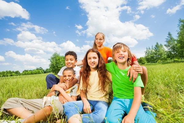 Happy kids sitting together — Stock Photo, Image