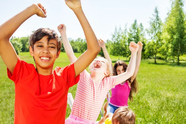 Happy kids with hands up — Stock Photo, Image