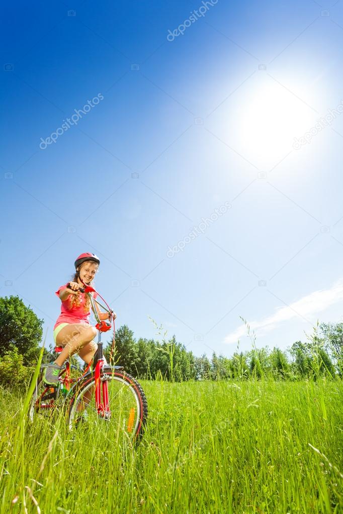 Nice young girl sitting on bike