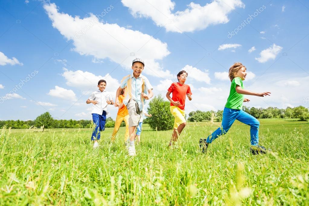 Kids playing and running in field
