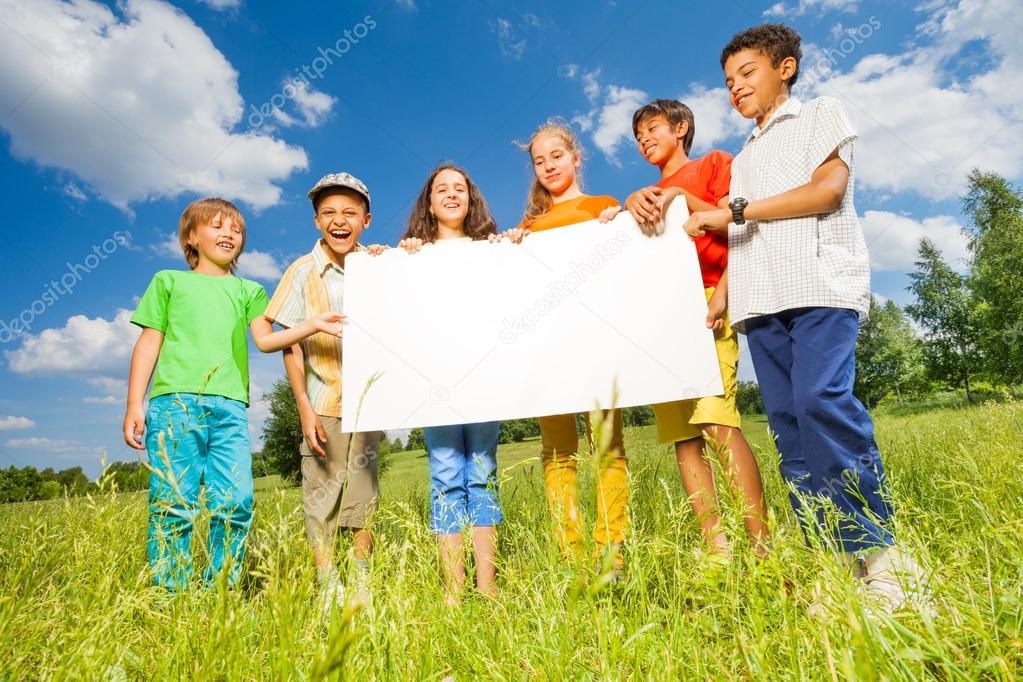 Children holding rectangular shape paper