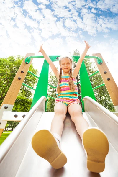 Girl on playground chute — Stock Photo, Image