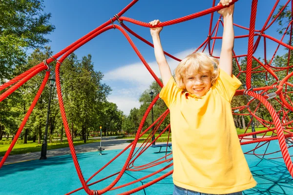 Active boy on red rope — Stock Photo, Image