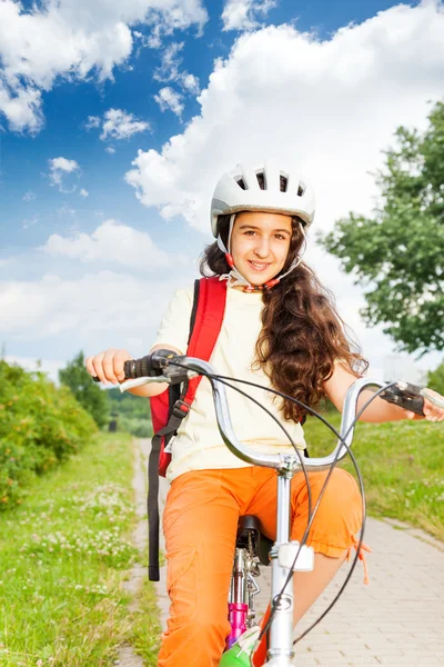 Girl with long hair rides bike — Stock Photo, Image