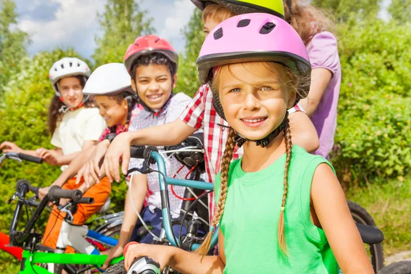 Girl in helmet and her friends — Stock Photo, Image