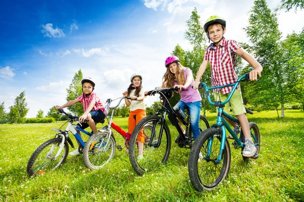 Happy kids in colorful bike helmets — Stock Photo, Image