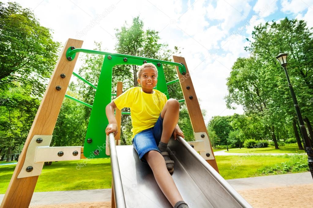 Smiling boys with bending knee on chute