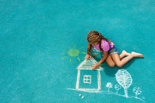 Dívka kreslení křídou dům obrázek — Stock fotografie