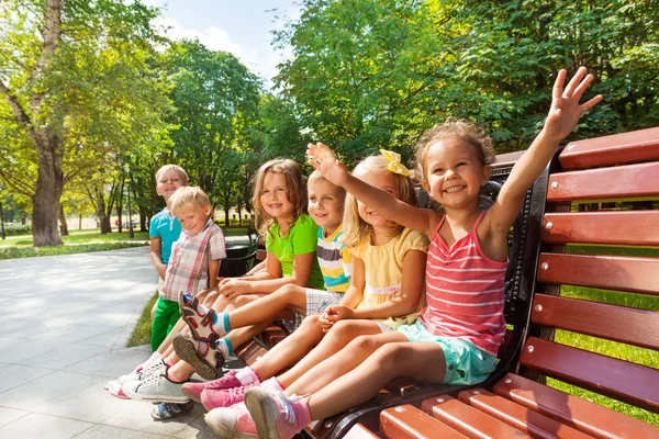 Boys and girls on bench — Stock Photo, Image