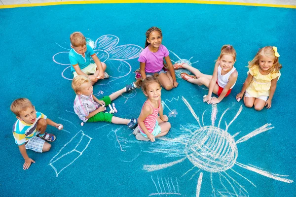 Children draw with chalk on playground — Stock Photo, Image