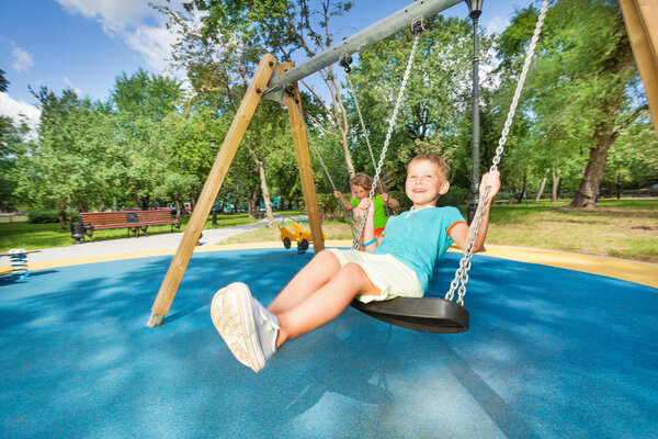 Boy and girl on swings