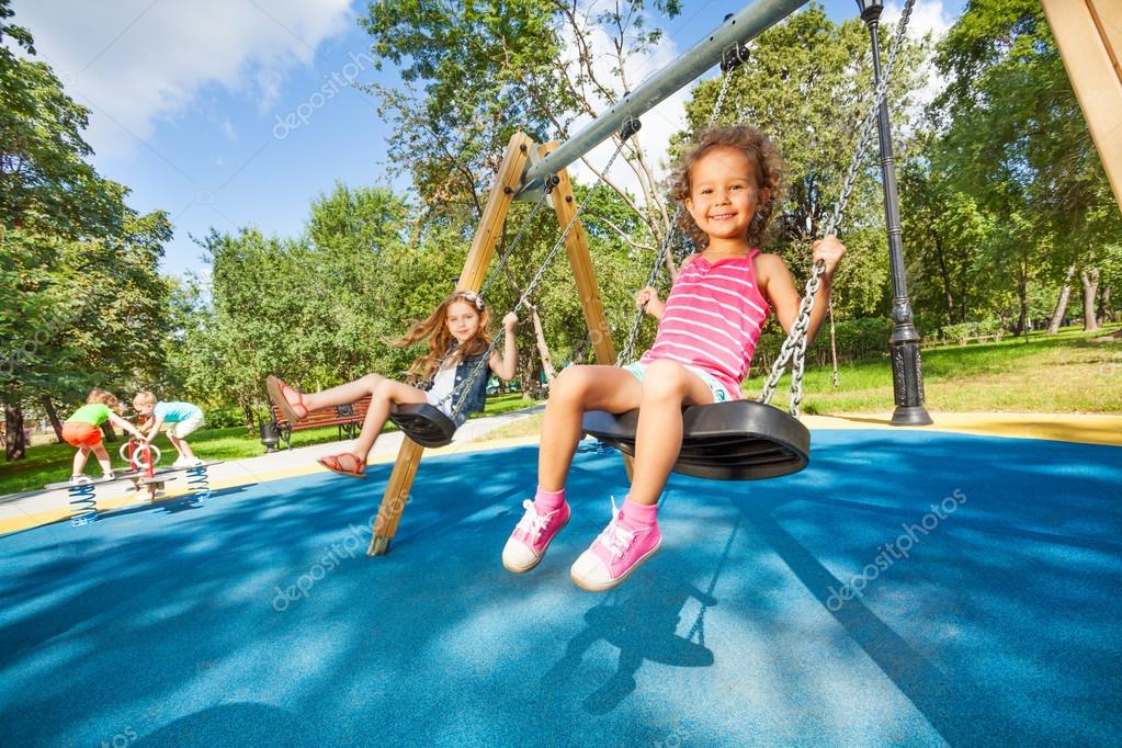 Kids swing on playground — Stock Photo © serrnovik 52724297