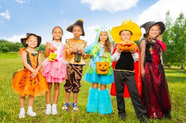 Happy children in Halloween costumes clipart