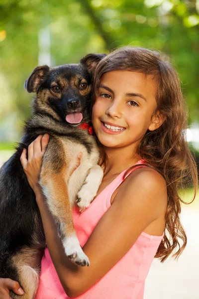 Teenage girl hugging little dog — Stock Photo, Image