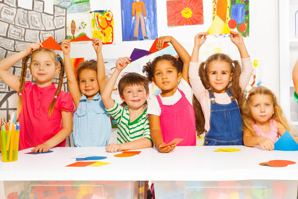 Kids showing cardboard shapes