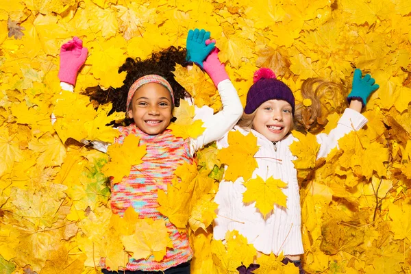 Happy girls covered with leaves — Stock Photo, Image