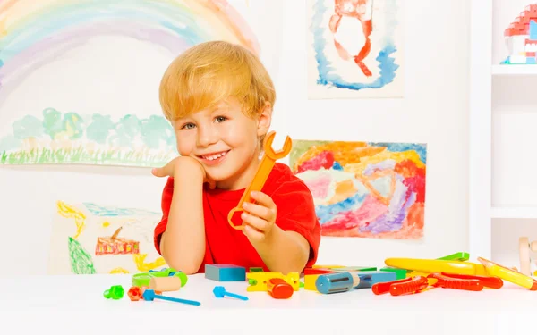 Boy holding plastic toy wrench — Stock Photo, Image