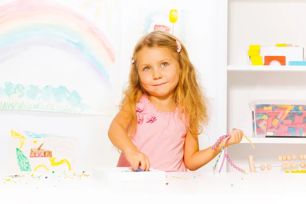 Girl with beads and strings — Stock Photo, Image