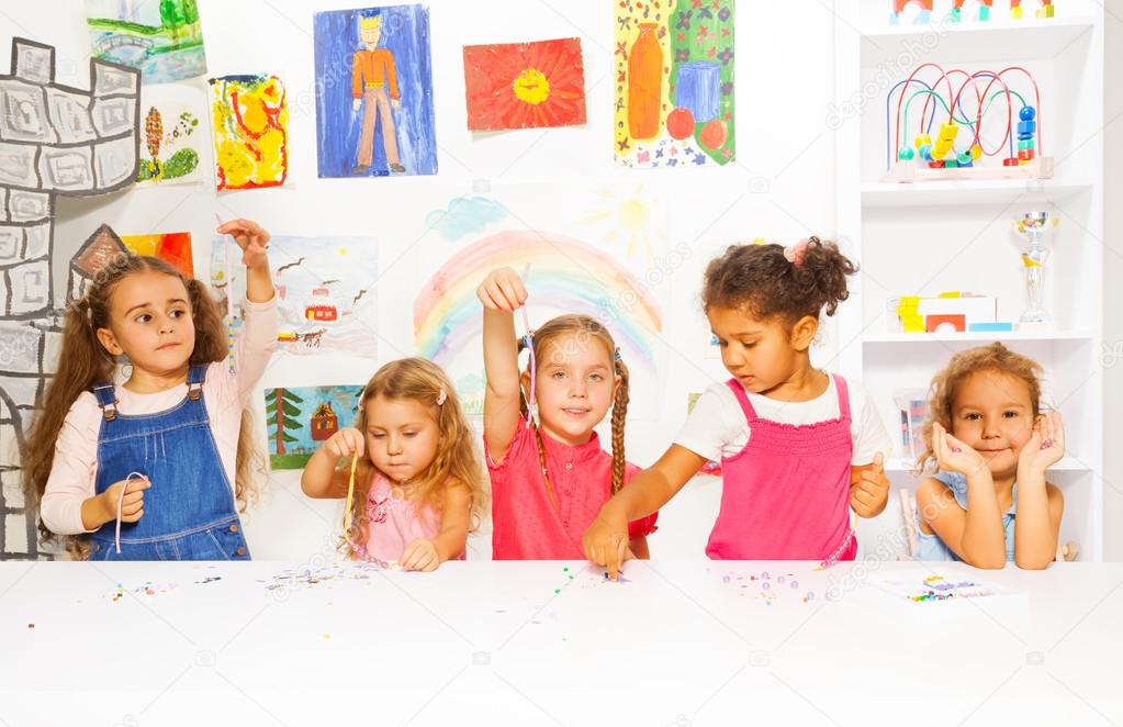 Girls playing with beads