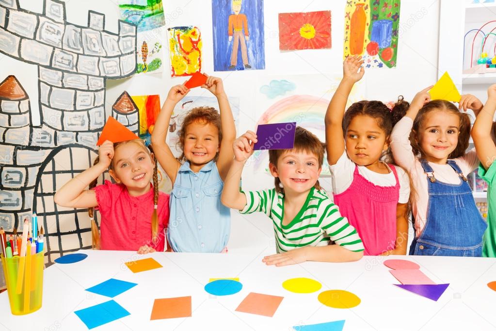 Kids showing cardboard shapes