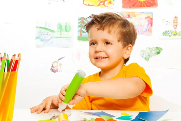 Boy crafting and holding glue — Stock Photo, Image