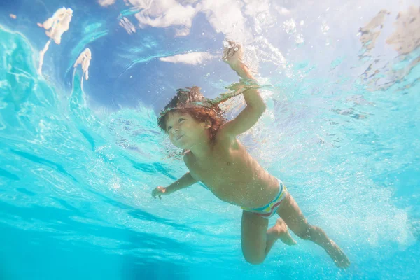 プールの水の下で泳いでいる少年 — ストック写真