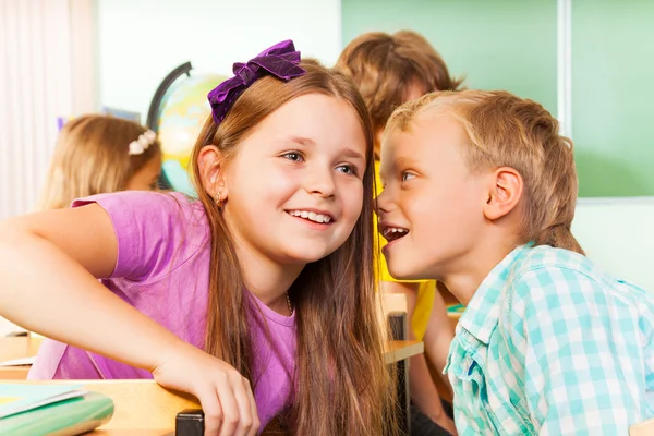 Boy tells secret to girl — Stock Photo, Image